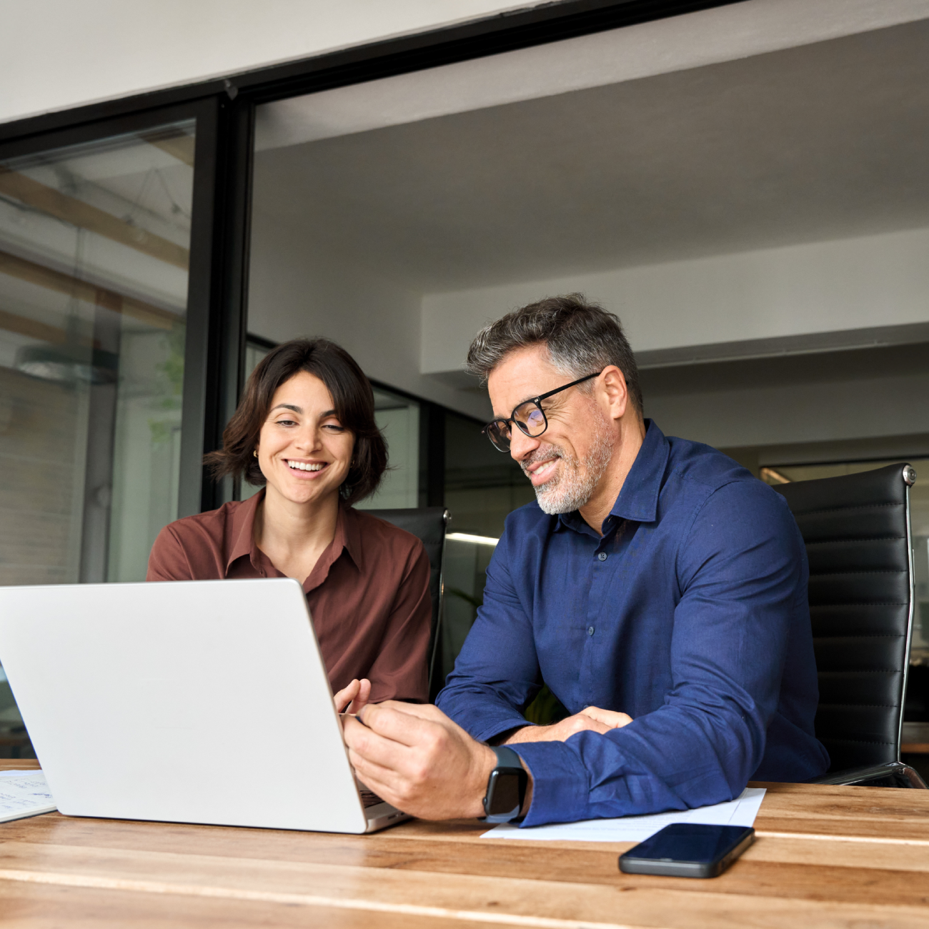 two-happy-busy-professionals-working-together-usin-2025-02-11-15-56-40-utc
